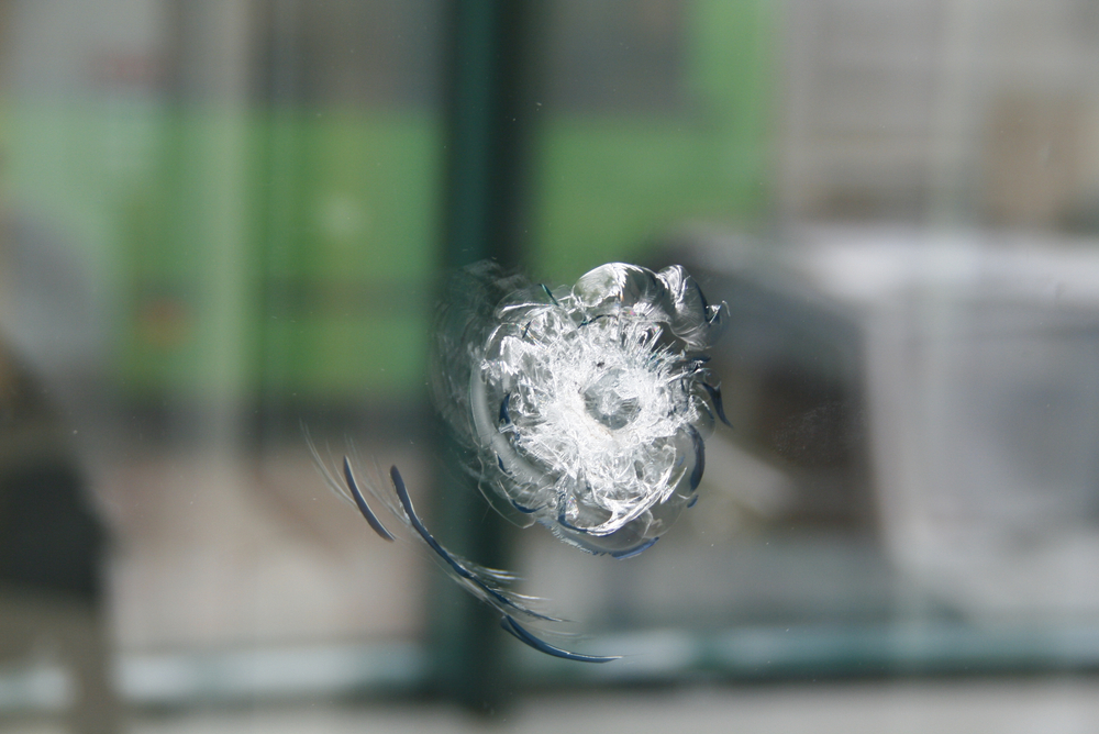 A round trace of bullets coming into the thick window glass(kamienczanka)s