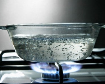 Boiling water in glass saucepan