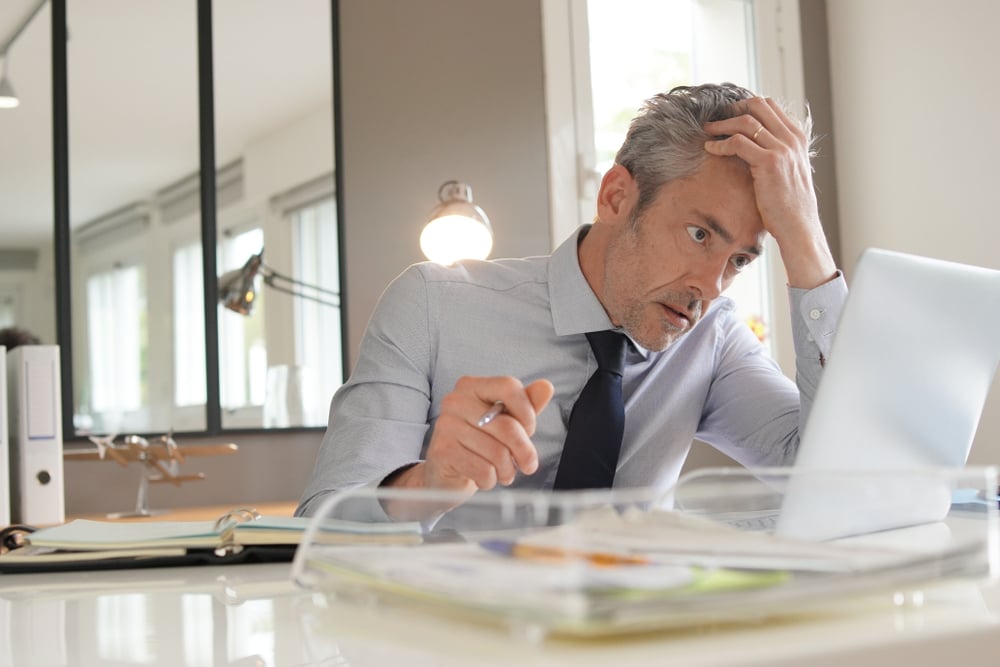 Stressed,Businessman,Working,In,Contemporary,Office