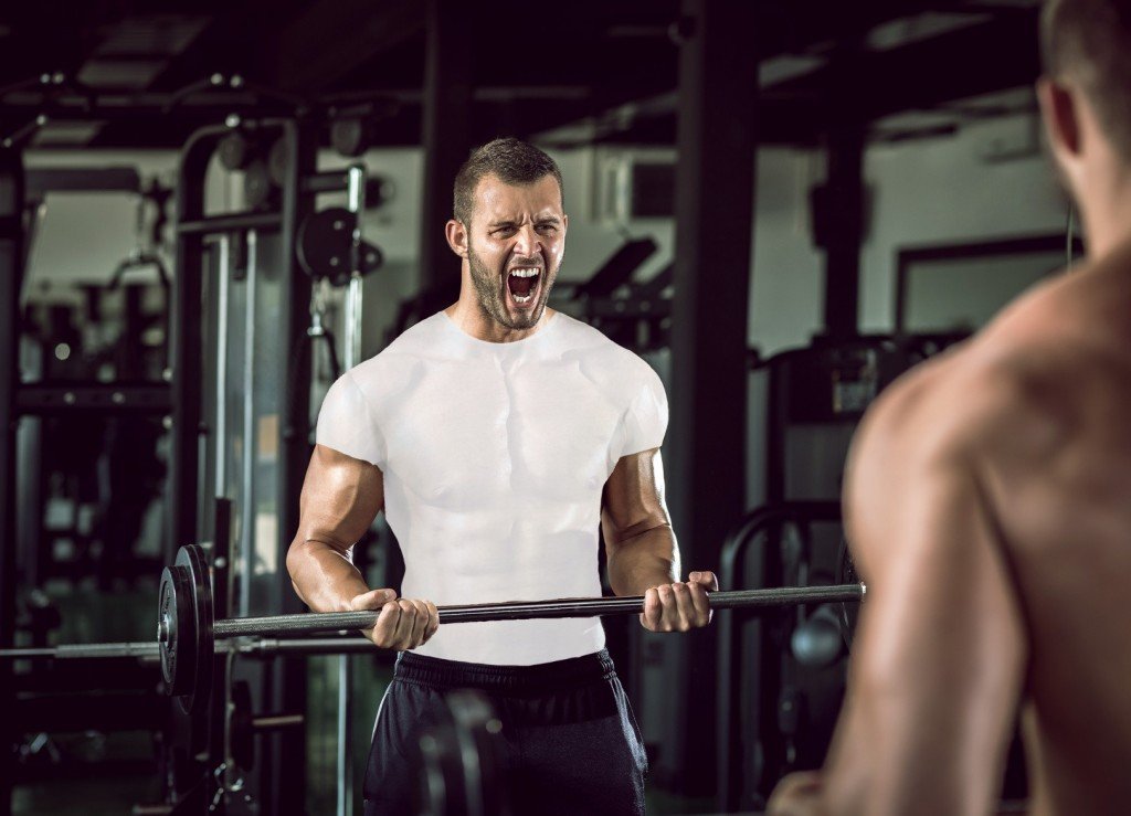 Man grunting in gym