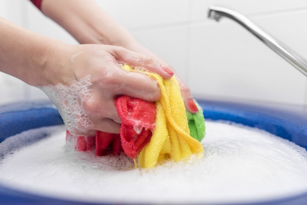 Washing cloths in hand How Does Soap Clean Dirty Clothes