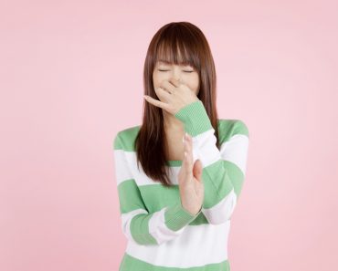Girl pinching her nose