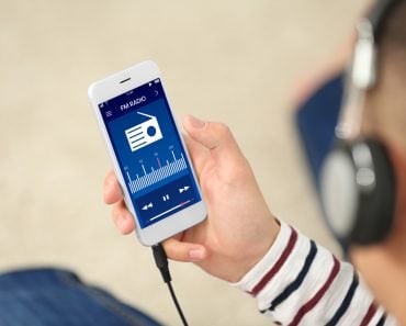 Man listening to radio on mobile phone indoors - Image( Africa Studio)s