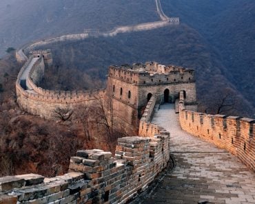 Great Wall sunset over mountains in Beijing, China.