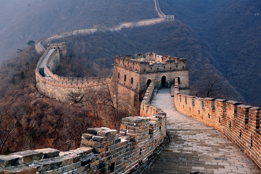 Great Wall sunset over mountains in Beijing, China.