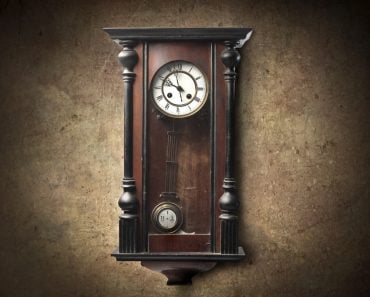 Old wooden pendulum hanging on a wall