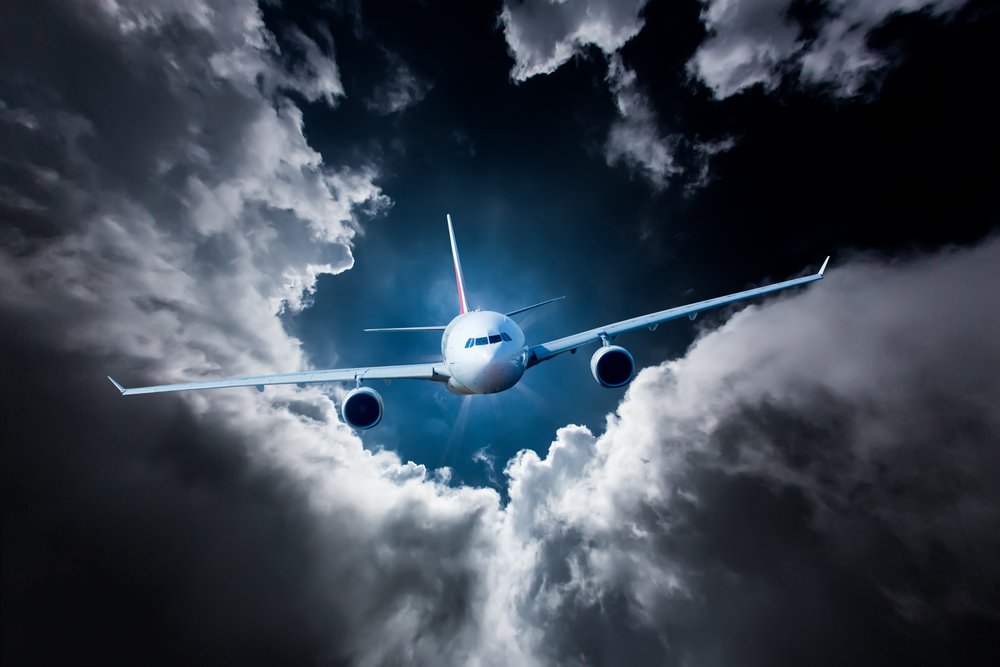 Passenger Airliner flying in the clouds airplane