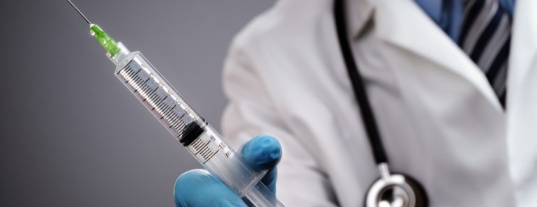 Doctor holding medical injection syringe and stethoscope anaesthesia medicine