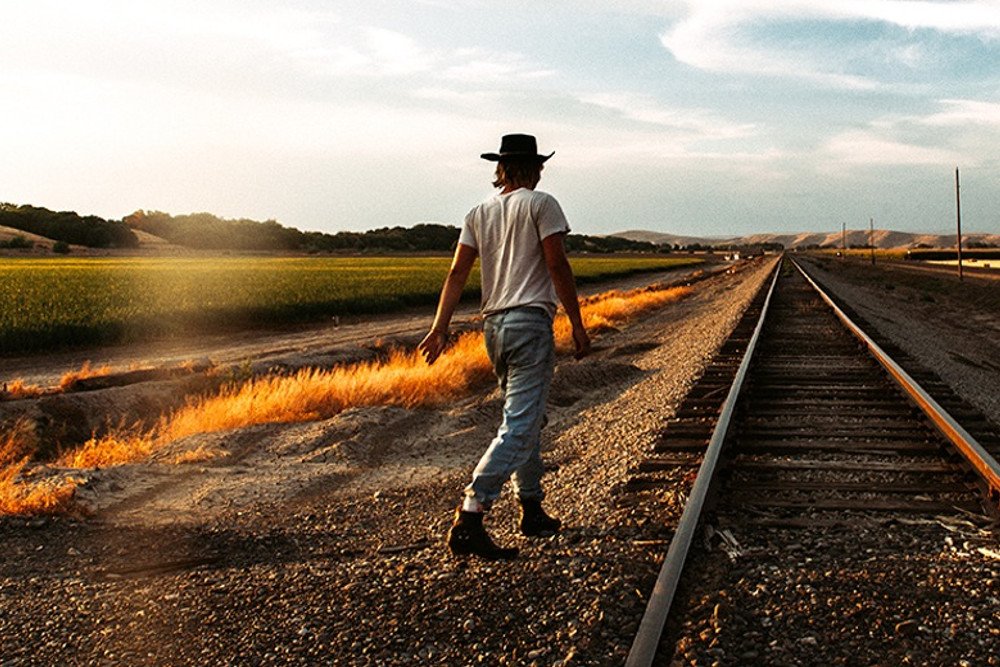 Man walking near railway track