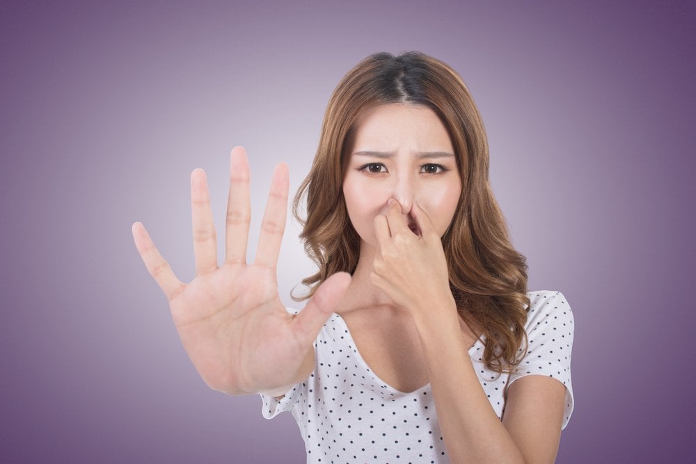 Portrait of a young woman holding her nose because of a linger bad smell girl. (elwynn)(s)