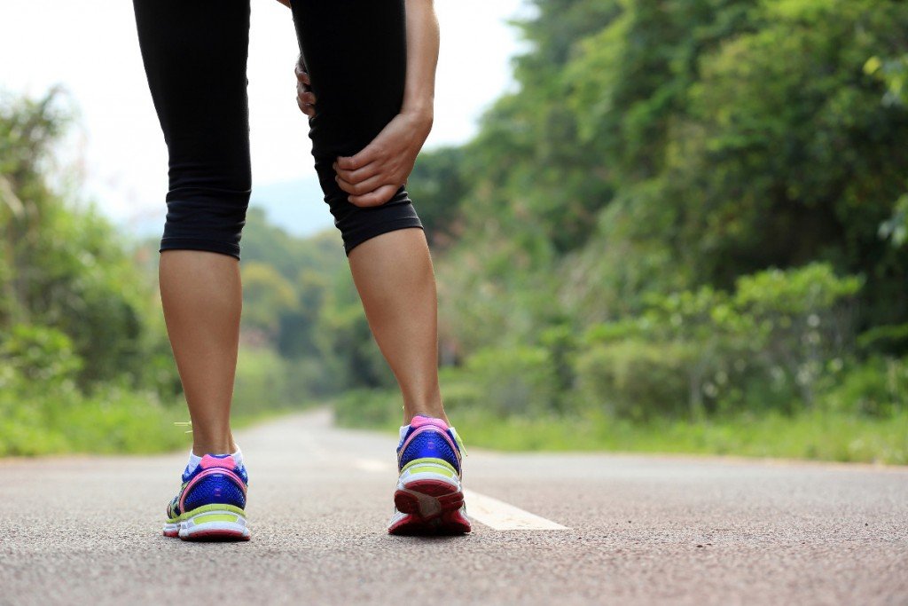 young fitness woman jogger hold her sports injured leg at forest trail (lzf)(s)