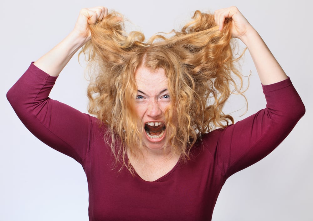 Woman Pulling Out frizz Hair