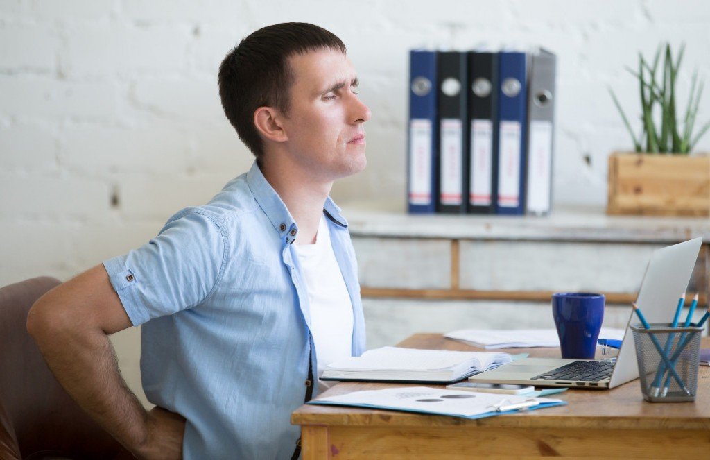 Man rubbing back pain