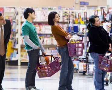 People in shopping mall queue for cashier counter