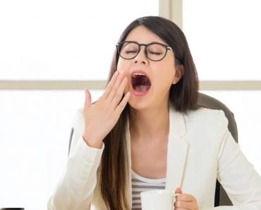 Yawning woman in office