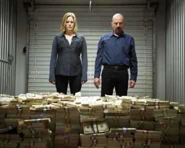 Breaking bad scene where Walter White and Skylar stand in front of a huge pile of cash