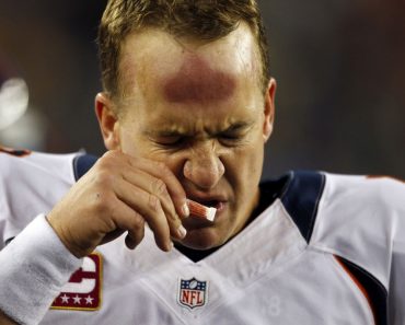 Denver Broncos quarterback Peyton Manning sniffs smelling salts