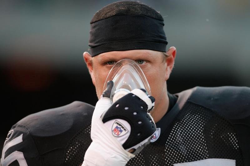 Athlete inhaling football player closeup