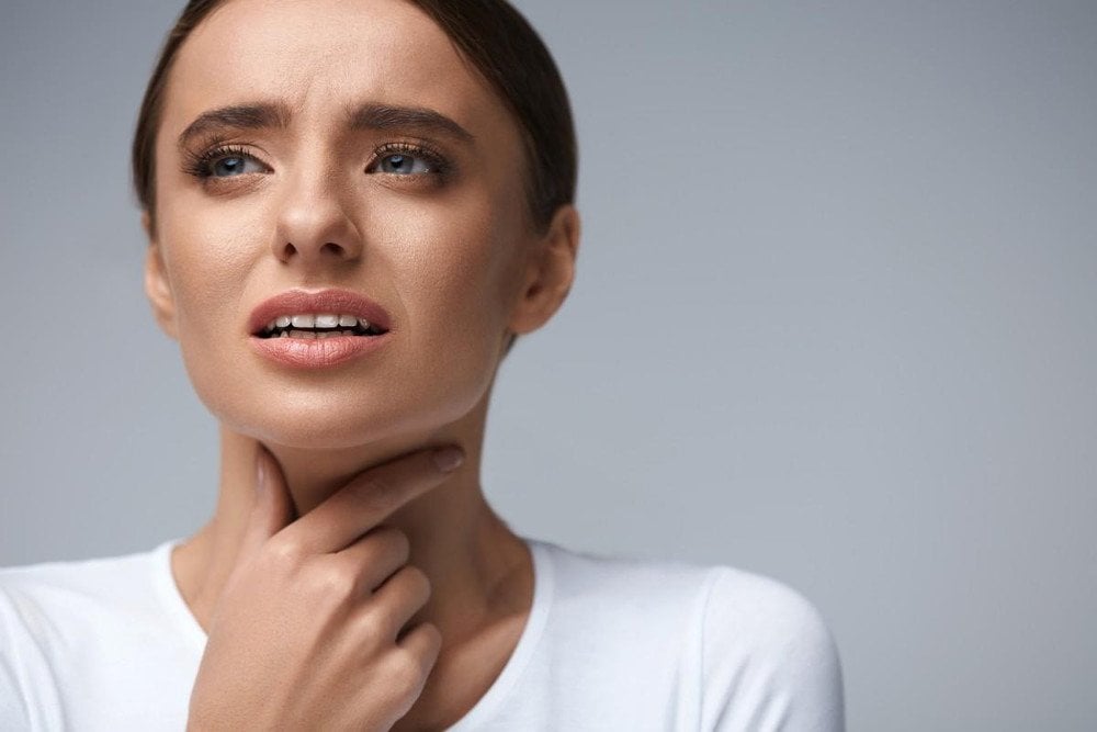 Throat Pain. Ill Woman With Sore Throat Feeling Bad, Suffering From Painful Swallowing, Strong Pain In Throat, Touching Neck With Hand. Beautiful Female Caught Cold. Health Concept. High Resolution