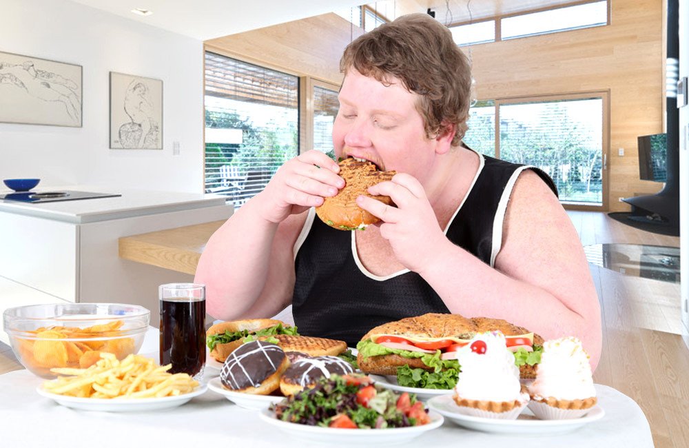 Fat man overeating food of full table