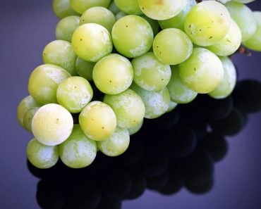 Green grapes on top of the table