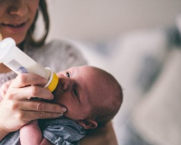 Little new born baby drinking bottle milk