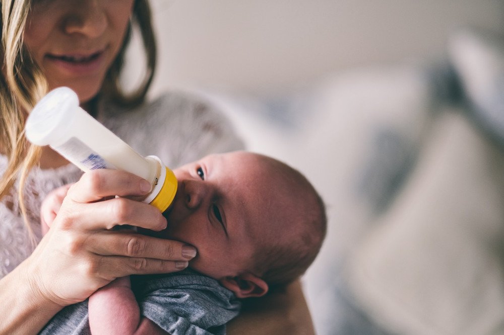 Little new born baby drinking bottle milk