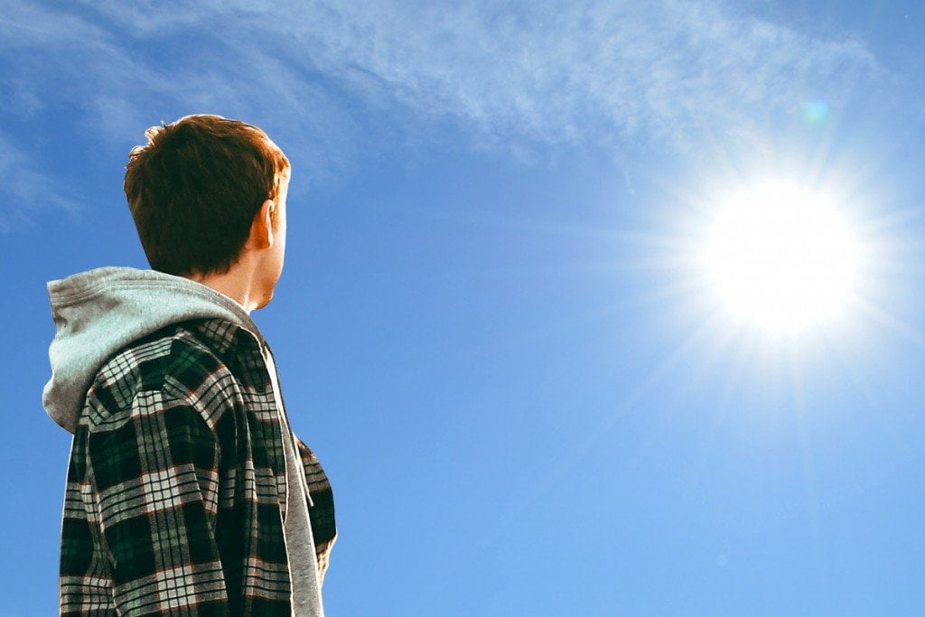 Young man looking at sun