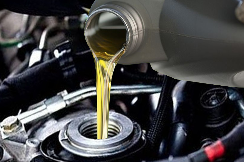 Pouring motor oil in engine
