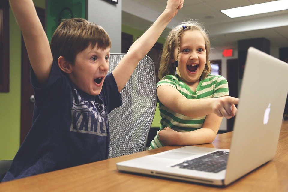 children playing video game computer laptop