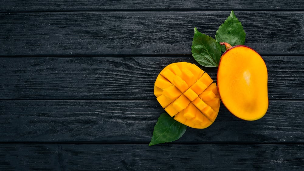 Mango. Tropical Fruits. On a wooden background. Top view. Copy space. - Image( YARUNIV Studio)s