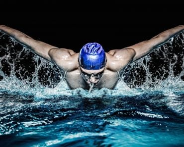 Muscular young man in blue cap in swimming pool - Image( Nejron Photo)s