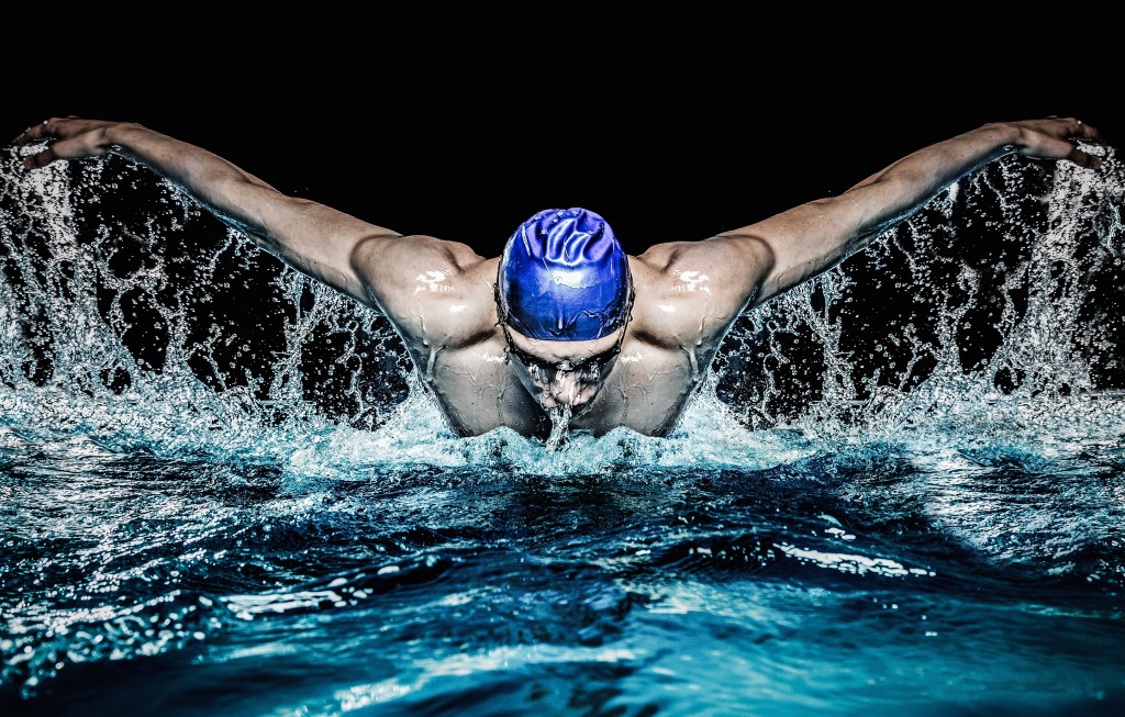 (Photo Credit : Nejron Photo/Shutterstock) Muscular young man in blue cap in swimming pool - Image( Nejron Photo)s