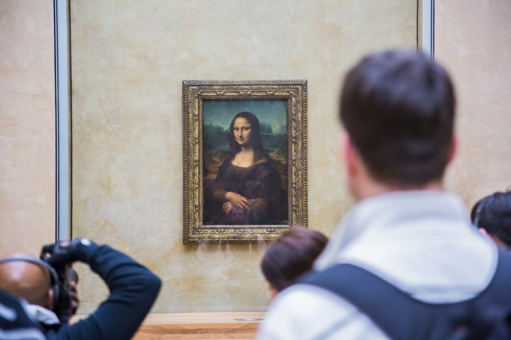 PARIS - AUGUST 4 Visitors take photo of Leonardo DaVinci's Mona Lisa at the Louvre Museum, August 4, 2012 in Paris, France. The painting is one of the world's most famous- Image(S-F)s
