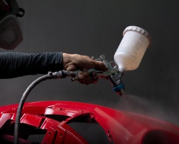 Auto body repair series Red bumper being painted in paint booth - Image(Bhakpong)s