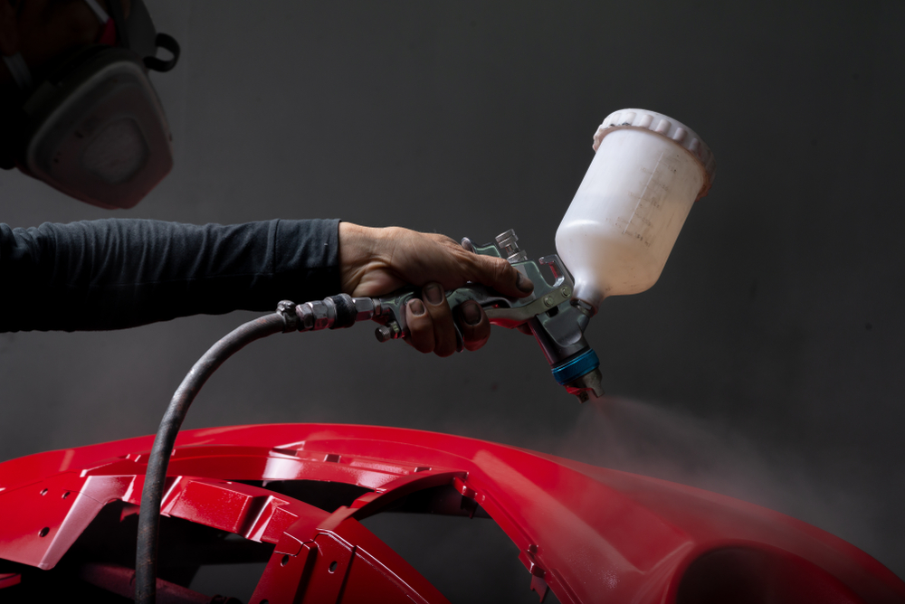 Auto body repair series Red bumper being painted in paint booth - Image(Bhakpong)s