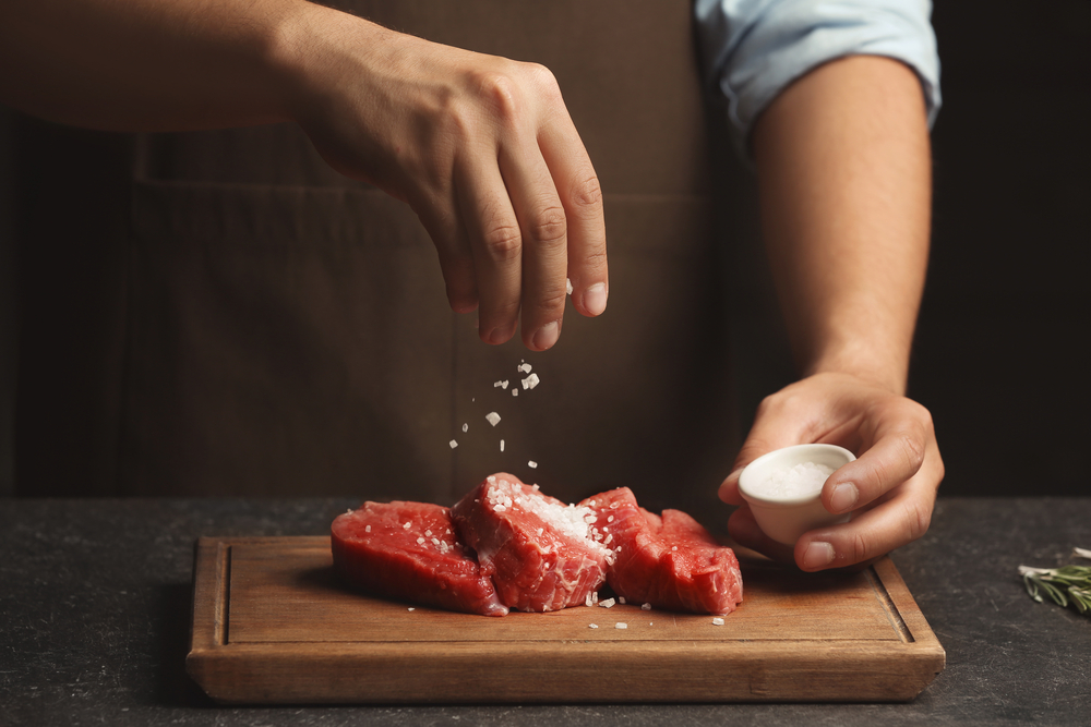 Chef cooking meat on table - Image( Africa Studio)s