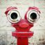 Red old fire hydrant on a street, looking like a face. Instagram style. Pareidolia. - Image(DG Stock)s