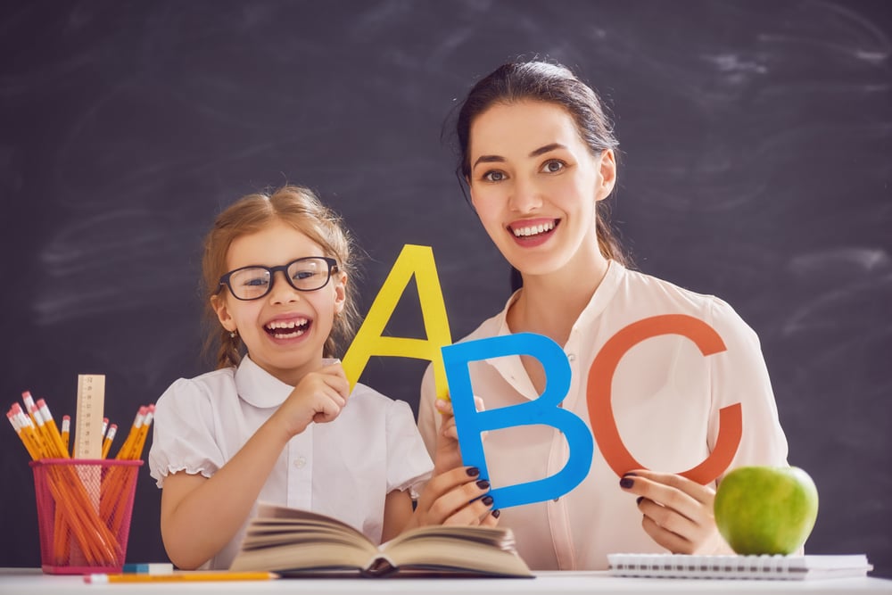 Back to school! Child is learning to write. Adult woman teaches child the alphabet. - Image( Yuganov Konstantin)s