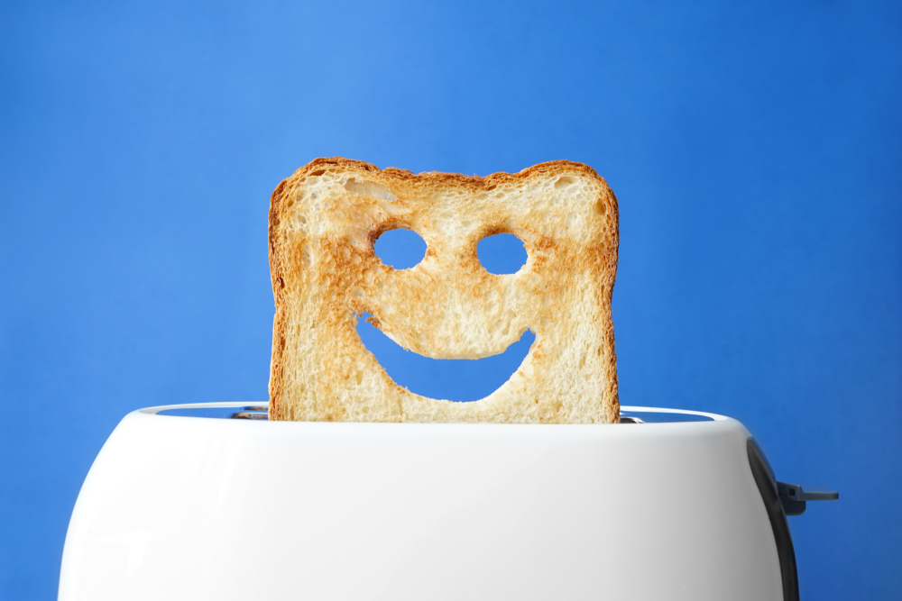 Funny slice of bread with toaster on color background( Pixel-Shot)s