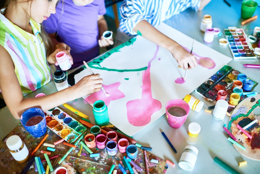 Group of unrecognizable children painting pictures with watercolors working together in art(SeventyFour)s