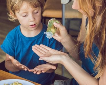 Mother and son using wash hand sanitizer gel in the cafe. - Image( Elizaveta Galitckaia)s