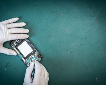 The abstract image of the technician repairing inside of smartphone by in the lab and green copy space is backdrop( Preechar Bowonkitwanchai)s