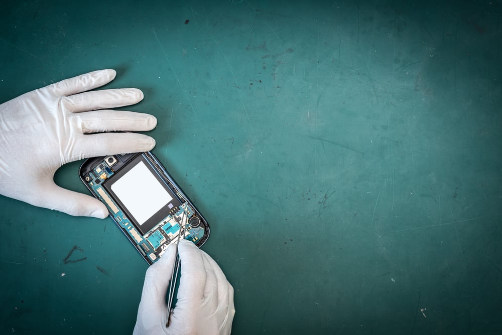 The abstract image of the technician repairing inside of smartphone by in the lab and green copy space is backdrop( Preechar Bowonkitwanchai)s