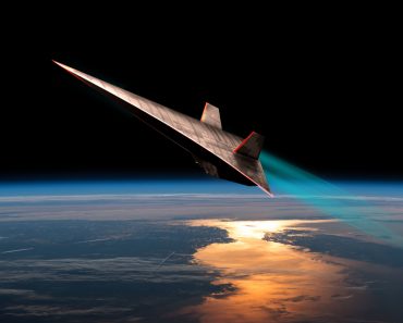 The leading edges of an unmanned scramjet glow from friction as it flys toward outer space near the edge of Earth's atmosphere(Marc Ward)s