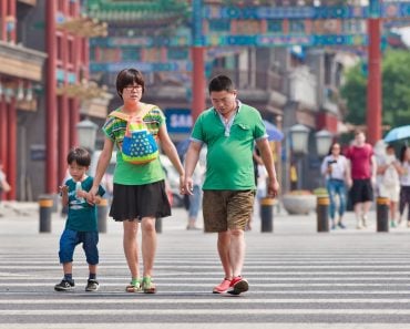 Chinese couple with child. China's one-child policy, initiated late 1970s(TonyV3112)s