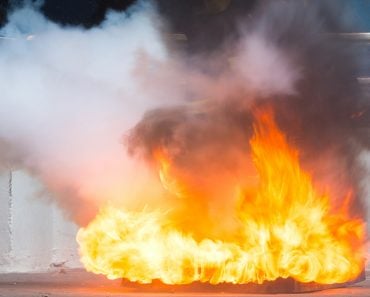 Instructor showing how to use a fire extinguisher on a training fire(sod tatong)s