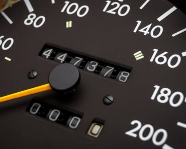 Close up shot of a speedometer in a car. Car dashboard odometer