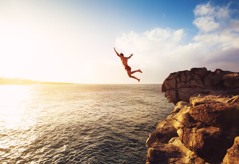 Cliff Jumping into the Ocean at Sunset(EpicStockMedia)S