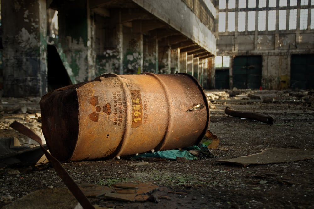 Radioactive warning on old rusty barrel in destroyed and forgotten building(Skorzewiak)s